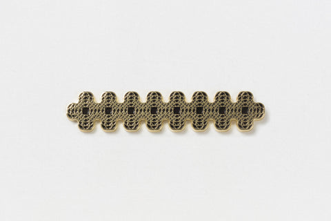 A rectangular gold pin with interlocking black circles resembling chainmaille