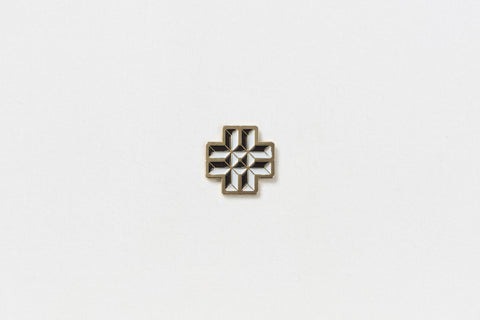 A square pin with a black and white hashtag and gold edges