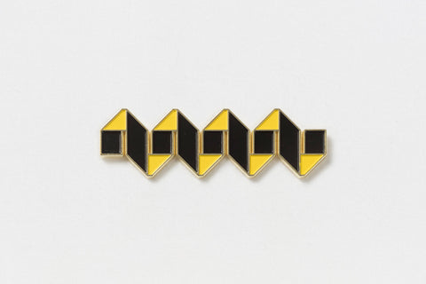 A black and yellow rectangular pin in the shape of a fret
