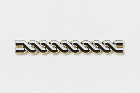 A long rectangular pin of black and white lines twisted around each other