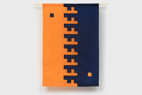 An orange and navy blue rectangular flag with opposite geometric designs