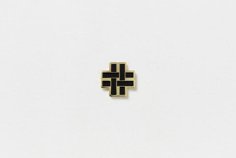 A square pin with a black hashtag and gold edges